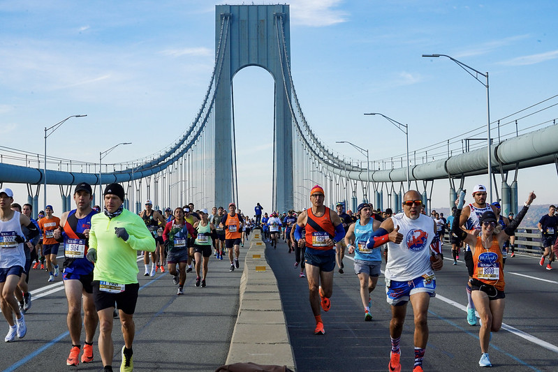 runners crossing bridge during nyc marathon